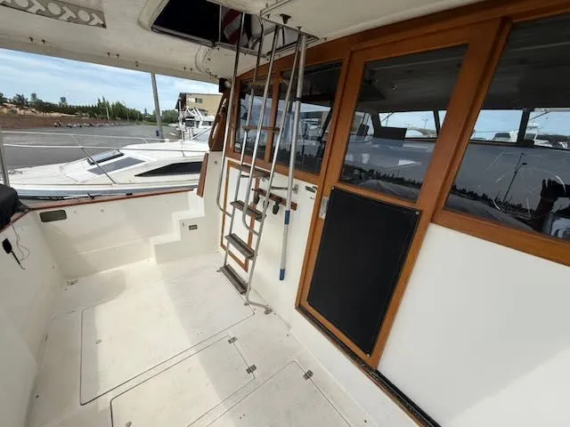 Slide: The Image of 1990 Bayliner 3888 Motoryacht with ladder and wooden doors at the dock. - 5