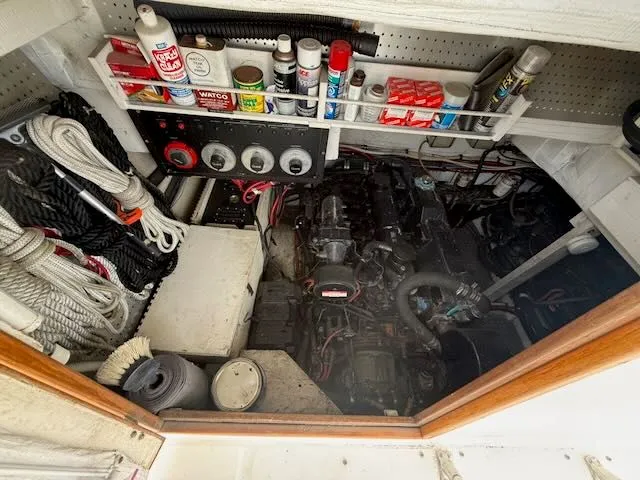 Slide: The Image of 1990 Bayliner 3888 Motoryacht engine room with tools and ropes. - 8
