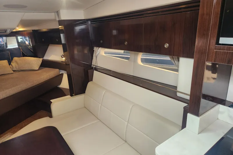 Slide: The Image of 2019 Sea Ray Sundancer 350 Coupe interior with elegant wood finishes and comfortable seating. - 13