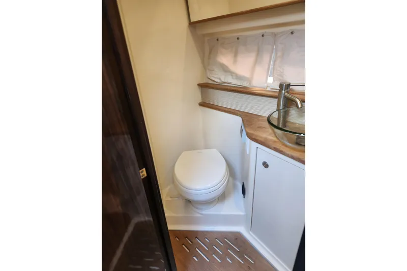 Slide: The Image of 2019 Sea Ray Sundancer 350 Coupe bathroom with modern fixtures and compact design. - 15