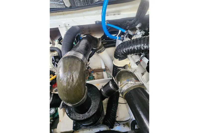 Slide: The Image of Engine compartment of 2019 Sea Ray Sundancer 350 Coupe with hoses and fittings. - 23