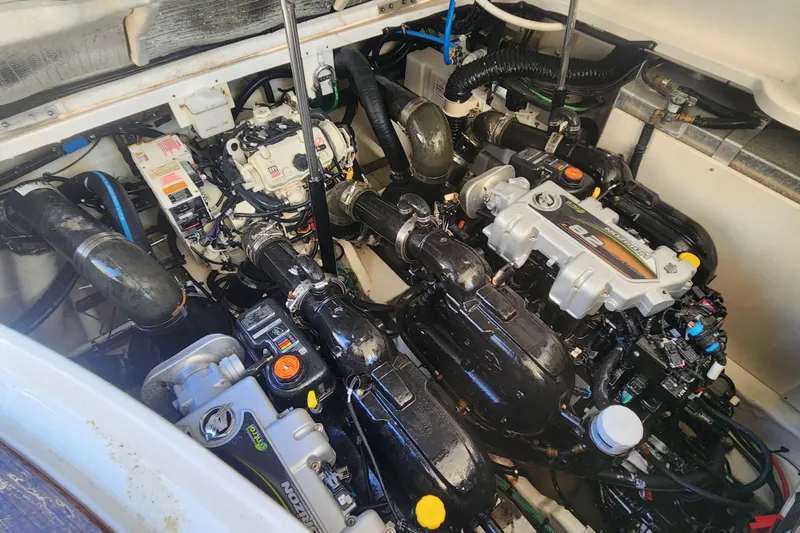 Slide: The Image of Engine compartment of a 2019 Sea Ray Sundancer 350 Coupe, showcasing dual engines and components. - 24