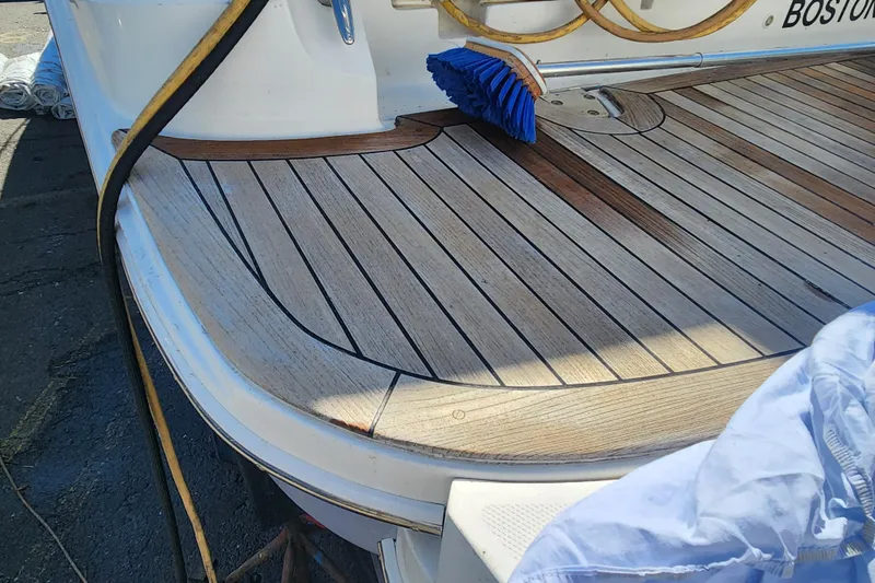 Slide: The Image of 2019 Sea Ray Sundancer 350 Coupe's teak deck with cleaning brush and hose. - 8
