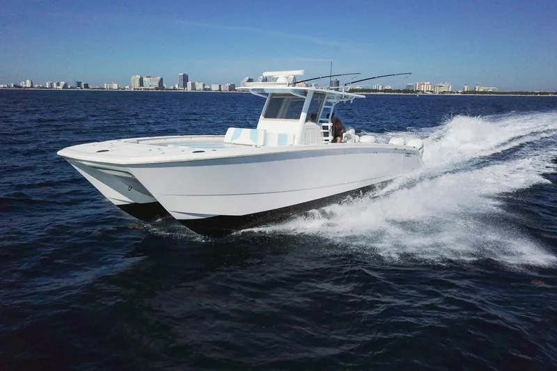 The Image of 2019 Invincible 40 Catamaran cruising on open water near city skyline. - 0