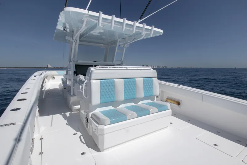 Slide: The Image of 2019 Invincible 40 Catamaran with blue and white seating on open water. - 11