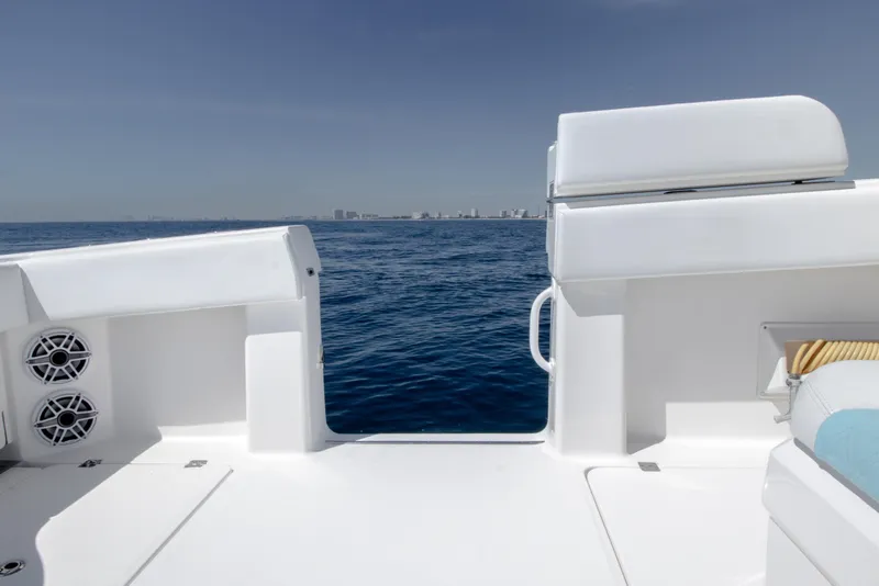 Slide: The Image of 2019 Invincible 40 Catamaran deck overlooking ocean with city skyline in distance. - 12