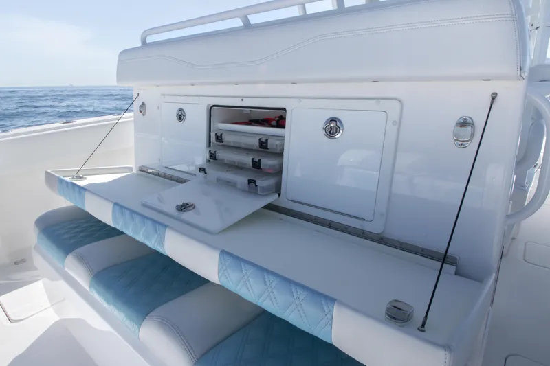 Slide: The Image of 2019 Invincible 40 Catamaran with open storage compartments and cushioned seating. - 13
