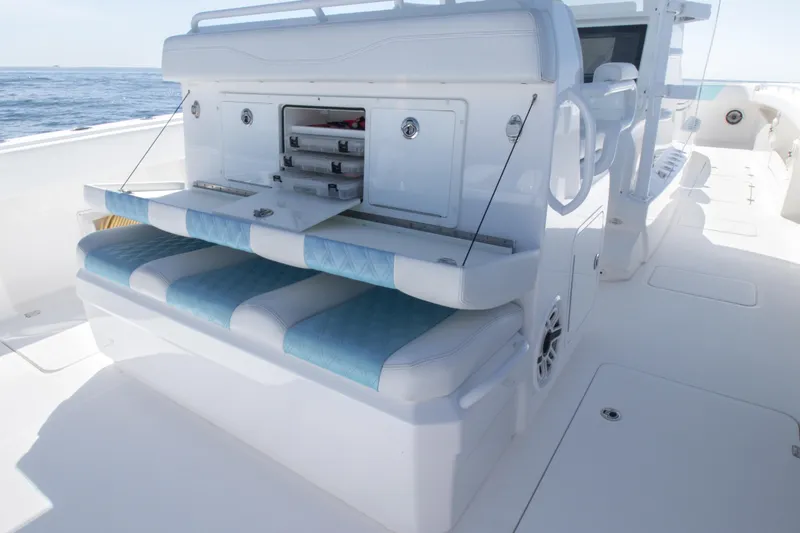 Slide: The Image of 2019 Invincible 40 Catamaran with open storage compartments and cushioned seating on deck. - 14