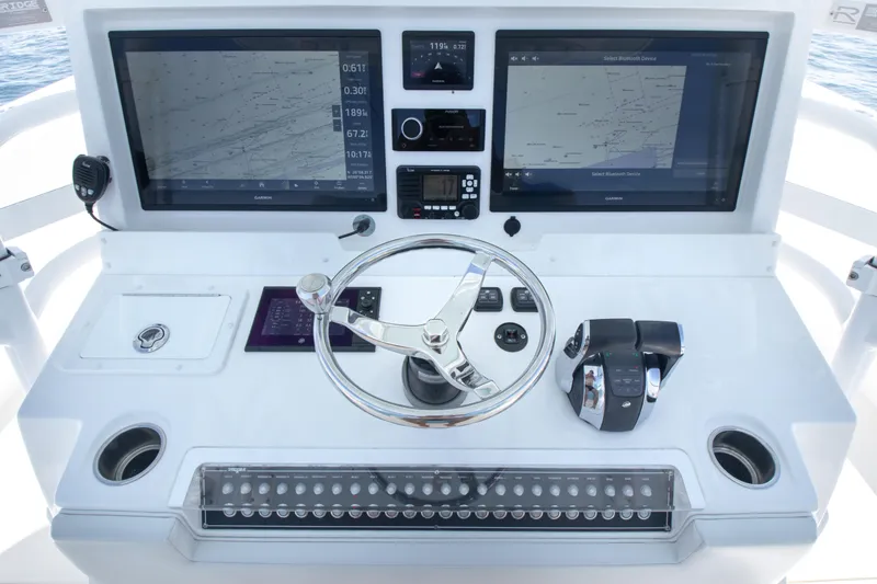 Slide: The Image of Control panel of 2019 Invincible 40 Catamaran with dual navigation screens and steering wheel. - 17