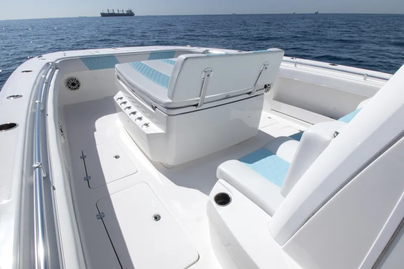 Slide: The Image of 2019 Invincible 40 Catamaran interior with seating, ocean view, and distant ship. - 19