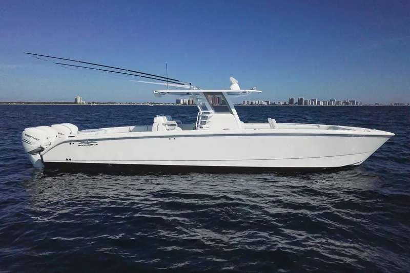 Slide: The Image of 2019 Invincible 40 Catamaran on open water, showcasing sleek design and powerful engines. - 2
