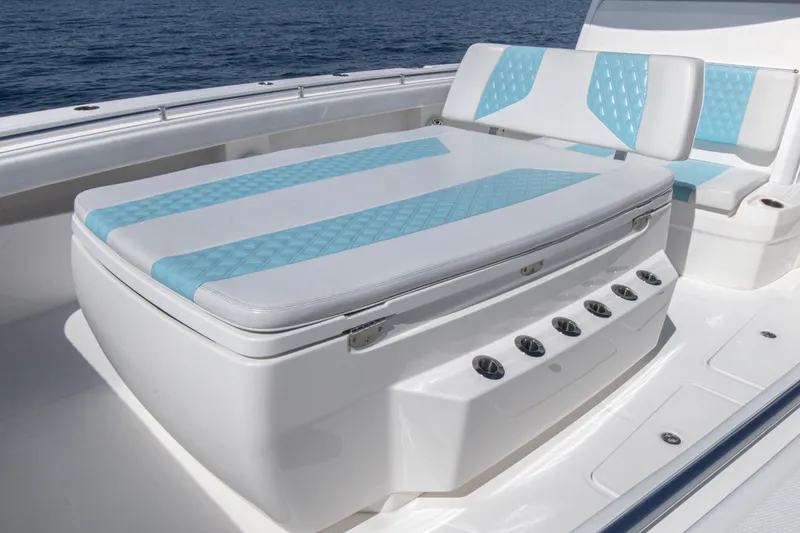 Slide: The Image of 2019 Invincible 40 Catamaran seating with blue and white upholstery on deck. - 21