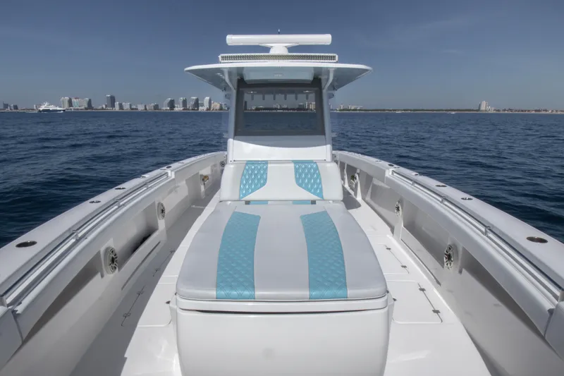 Slide: The Image of Invincible 40 Catamaran 2019 on open water with city skyline in background. - 22