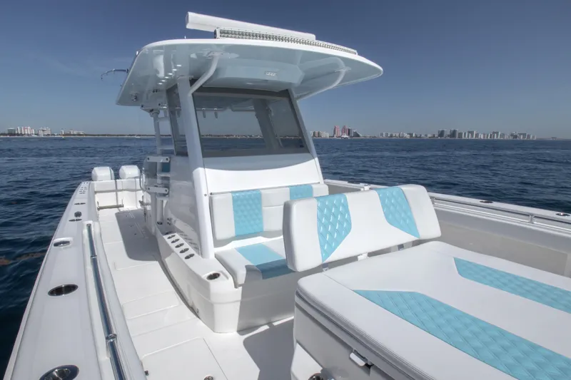 Slide: The Image of 2019 Invincible 40 Catamaran on open water, featuring sleek design and modern seating. - 25