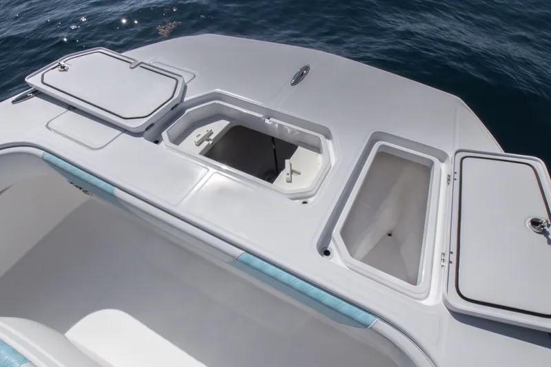 Slide: The Image of 2019 Invincible 40 Catamaran deck with open storage compartments on the ocean. - 26