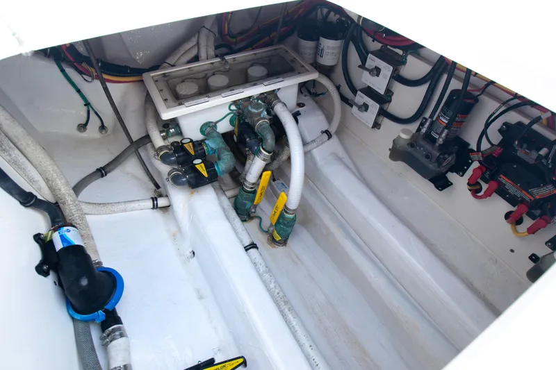 Slide: The Image of Engine compartment of a 2019 Invincible 40 Catamaran, showcasing wiring and mechanical components. - 27