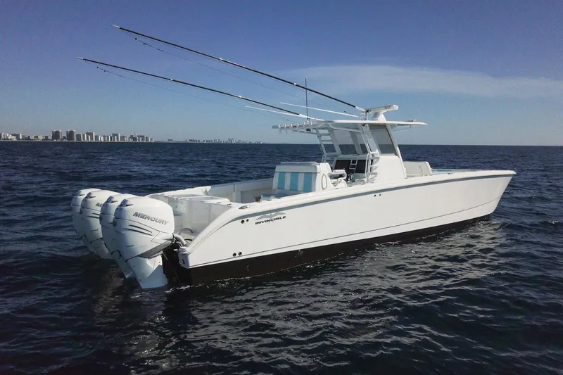 Slide: The Image of 2019 Invincible 40 Catamaran with triple Mercury engines on open sea. - 3