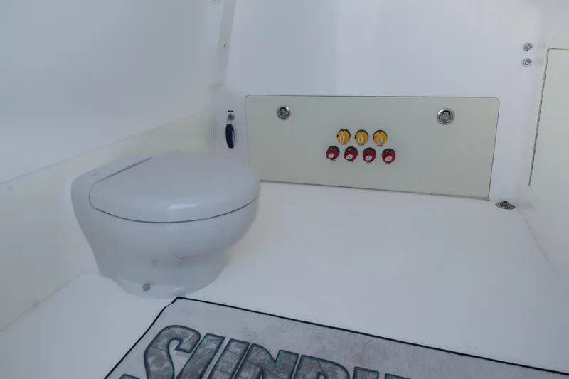 Slide: The Image of Interior of 2019 Invincible 40 Catamaran featuring a marine toilet and control panel. - 31
