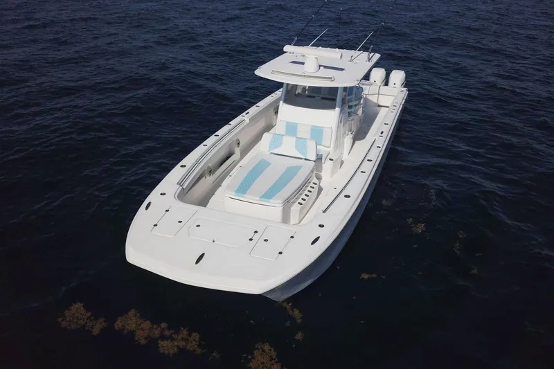 Slide: The Image of 2019 Invincible 40 Catamaran on open water, showcasing sleek design and spacious deck. - 5