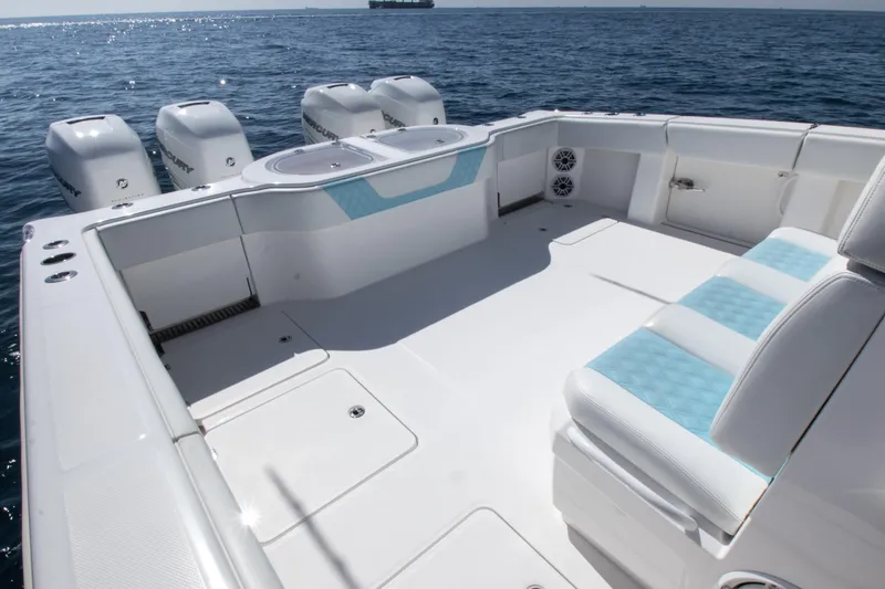 Slide: The Image of 2019 Invincible 40 Catamaran deck with seating and multiple outboard engines. - 9