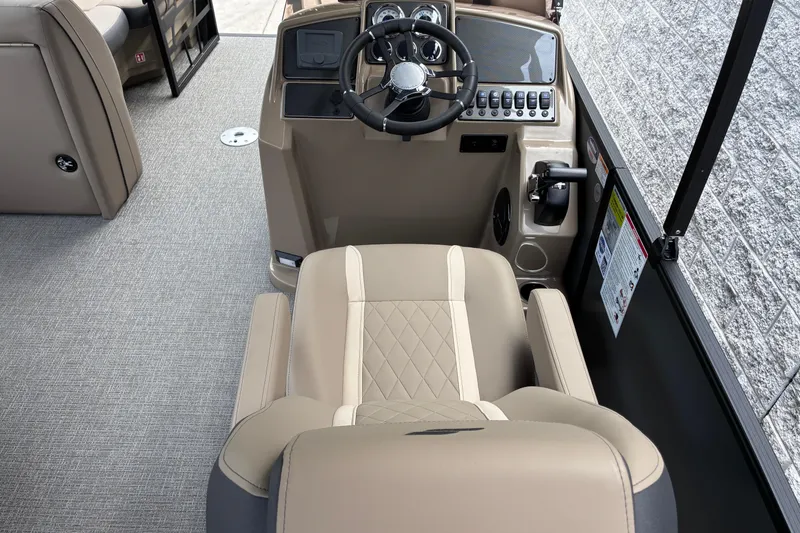 Slide: The Image of Captain's seat and helm of 2026 Starcraft EXS 1 Q DH boat, featuring modern controls. - 14