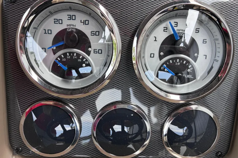 Slide: The Image of Dashboard gauges of a 2026 Starcraft EXS 1 Q DH boat, displaying speed, RPM, voltage, and fuel levels. - 18