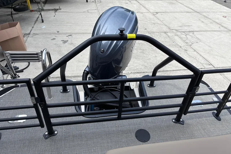 Slide: The Image of 2026 Starcraft EXS 1 Q DH boat with outboard motor and safety railing. - 22
