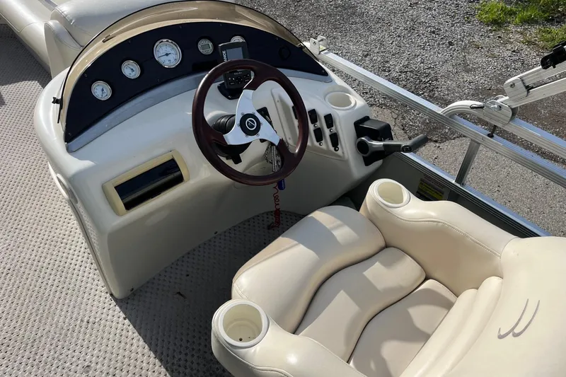 Slide: The Image of 2004 Bennington 2250RL boat dashboard with steering wheel and gauges. - 5