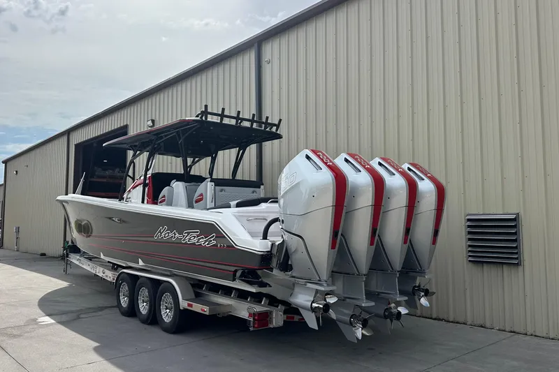 The Image of 2026 Nor-Tech 390 Sport Center Console boat with quad engines on a trailer. - 1