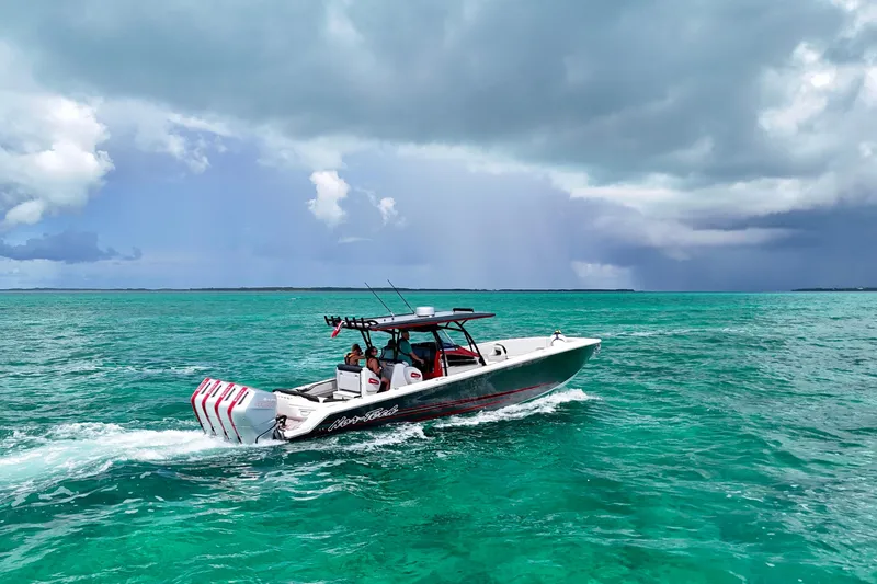 Slide: The Image of 2026 Nor-Tech 390 Sport Center Console cruising on turquoise ocean under cloudy sky. - 12
