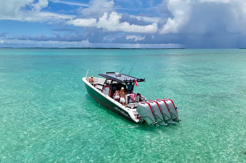 Slide: The Image of 2026 Nor-Tech 390 Sport Center Console cruising on clear turquoise waters under a blue sky. - 13