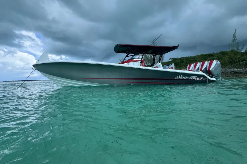 Slide: The Image of 2026 Nor-Tech 390 Sport Center Console boat on turquoise water under cloudy sky. - 16