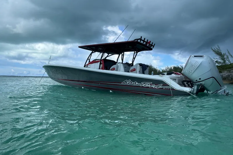 Slide: The Image of 2026 Nor-Tech 390 Sport Center Console boat on turquoise water under cloudy sky. - 17