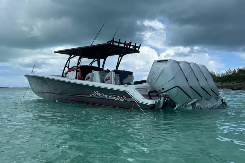 Slide: The Image of 2026 Nor-Tech 390 Sport Center Console boat on turquoise water under cloudy sky. - 18