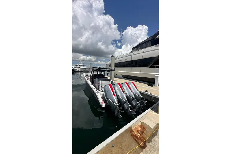 Slide: The Image of 2026 Nor-Tech 390 Sport Center Console docked, featuring multiple powerful outboard engines. - 3