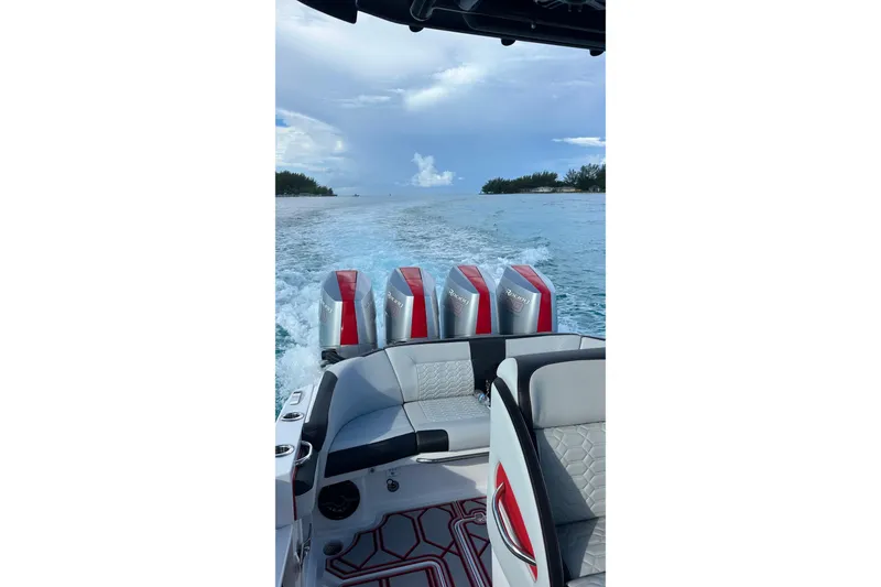Slide: The Image of 2026 Nor-Tech 390 Sport Center Console cruising on open water, showcasing powerful engines. - 4
