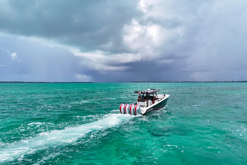 Slide: The Image of 2026 Nor-Tech 390 Sport Center Console cruising on turquoise ocean under cloudy sky. - 9