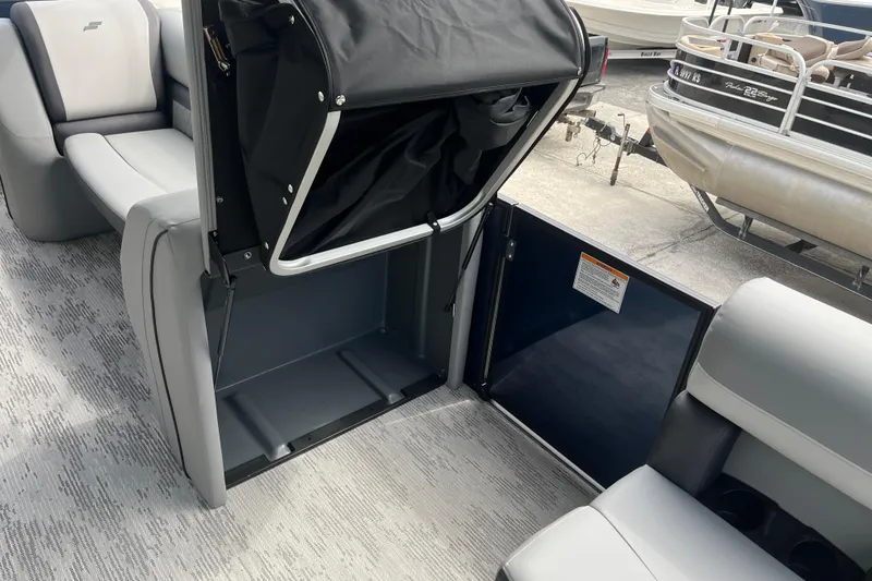 Slide: The Image of 2026 Starcraft EXS 3 FD boat interior with seating and storage compartment. - 18