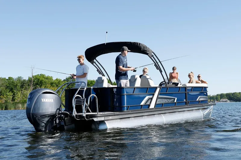 Slide: The Image of Manufacturer Provided Image: 2026 Starcraft EXS 3 FD pontoon boat on a lake with people fishing and relaxing. - 2
