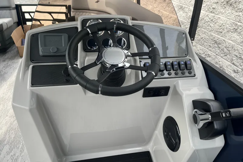 Slide: The Image of 2026 Starcraft EXS 3 FD boat dashboard with steering wheel and control panel. - 23