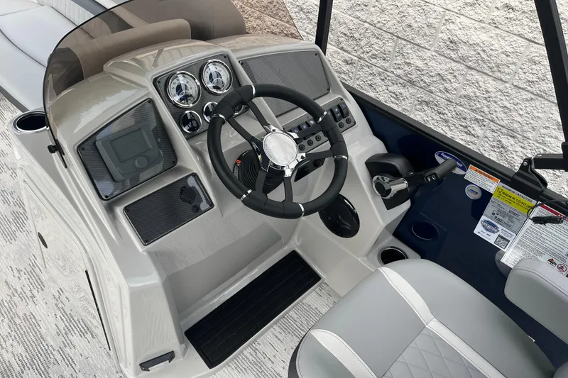 Slide: The Image of 2026 Starcraft EXS 3 FD boat dashboard with steering wheel and control panel. - 24