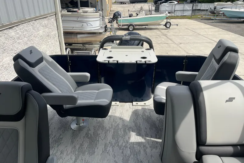 Slide: The Image of 2026 Starcraft EXS 3 FD boat interior with modern seating and steering console. - 26