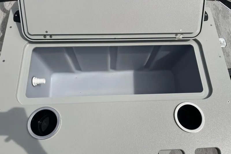Slide: The Image of Open storage compartment on 2026 Starcraft EXS 3 FD boat, featuring cup holders. - 28