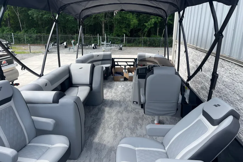 Slide: The Image of 2026 Starcraft EXS 3 FD pontoon boat interior with gray seating and canopy. - 32