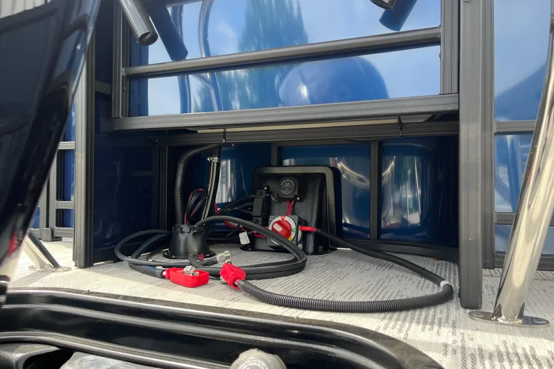 Slide: The Image of Battery compartment of 2026 Starcraft EXS 3 FD boat with cables and connectors. - 40