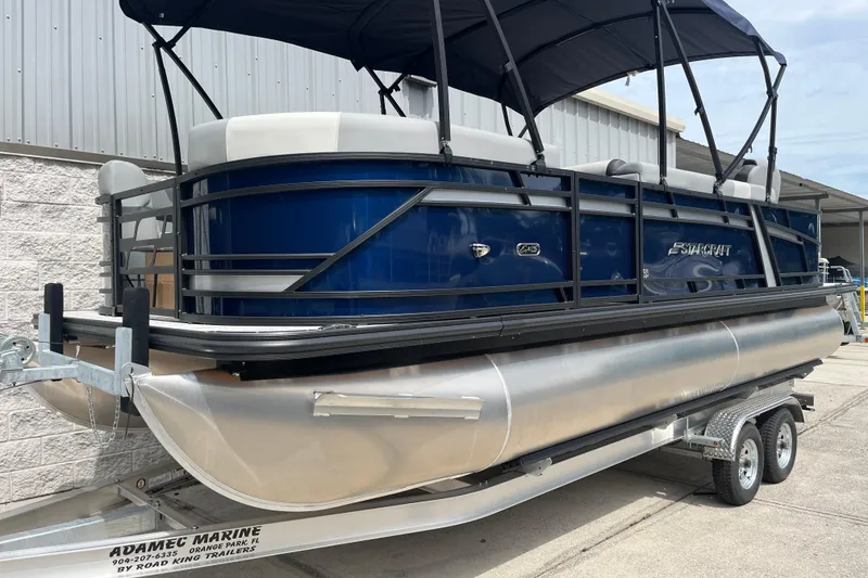 Slide: The Image of 2026 Starcraft EXS 3 FD pontoon boat on trailer, featuring sleek blue design. - 45