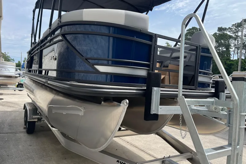 Slide: The Image of 2026 Starcraft EXS 3 FD pontoon boat on trailer, featuring sleek blue design. - 48