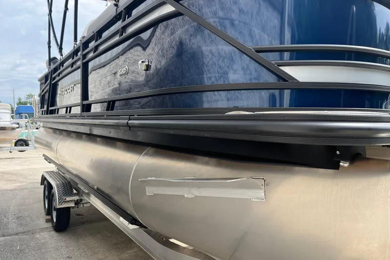 Slide: The Image of 2026 Starcraft EXS 3 FD pontoon boat on trailer, showcasing sleek design and metallic finish. - 50