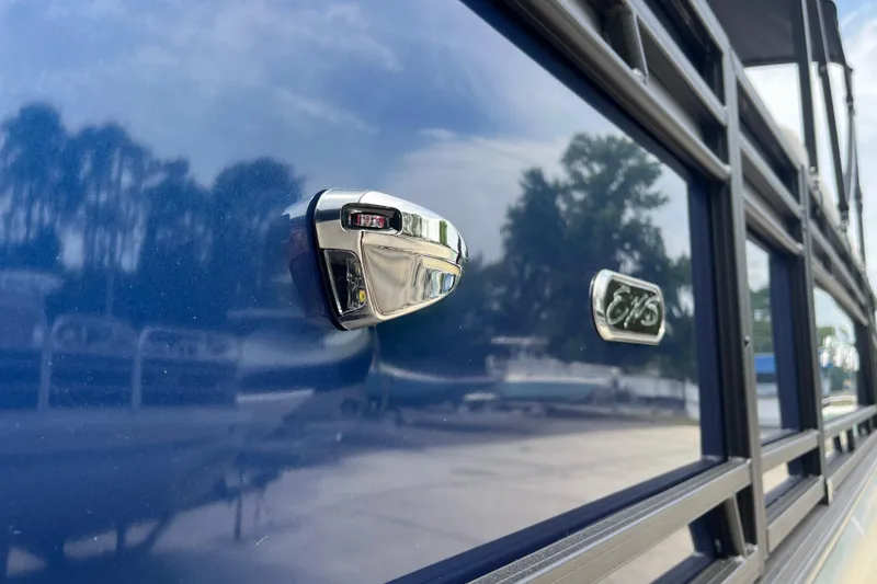 Slide: The Image of 2026 Starcraft EXS 3 FD boat exterior with chrome details and reflective blue finish. - 52