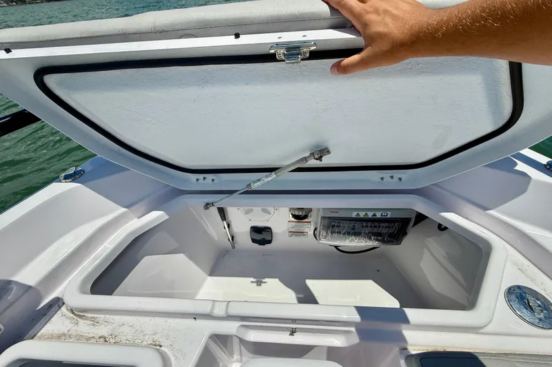 Slide: The Image of Open storage compartment on 2025 Axopar 29 Sun-Top boat, showcasing interior space. - 17